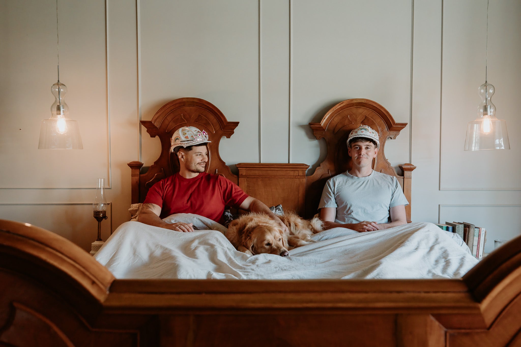 Jordan and Dane in bed with Mango the golden retriever